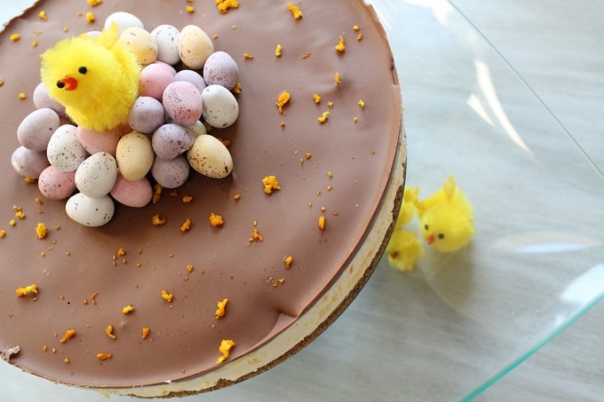 Chocolate Orange Mini Egg Cheesecake decorated with mini eggs and mini easter chick decorations