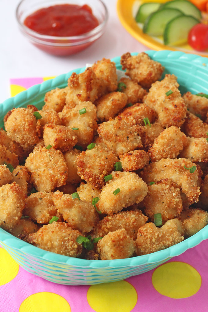 Close up of Baked Popcorn Chicken with green chopped chives