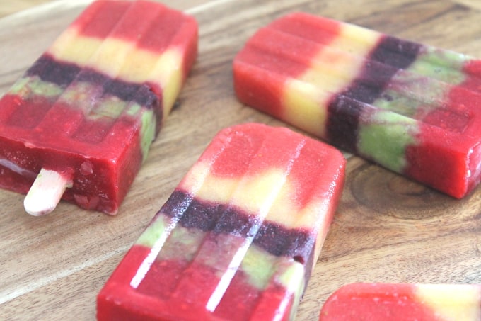 fruit ice pops on wooden chopping board