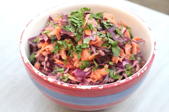 red cabbage coleslaw in stripy bowl
