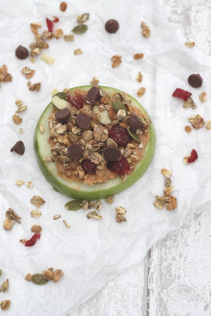 apple slices topped with peanut butter, granola and chocolate chips