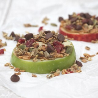 apple slices topped with peanut butter, granola and chocolate chips