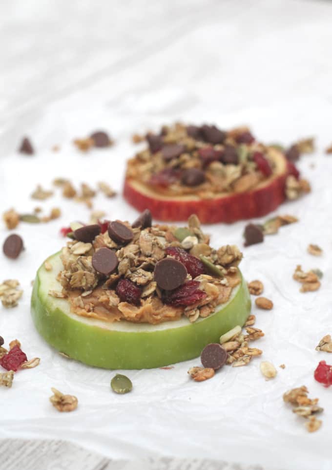 apple slices topped with peanut butter, granola and chocolate chips