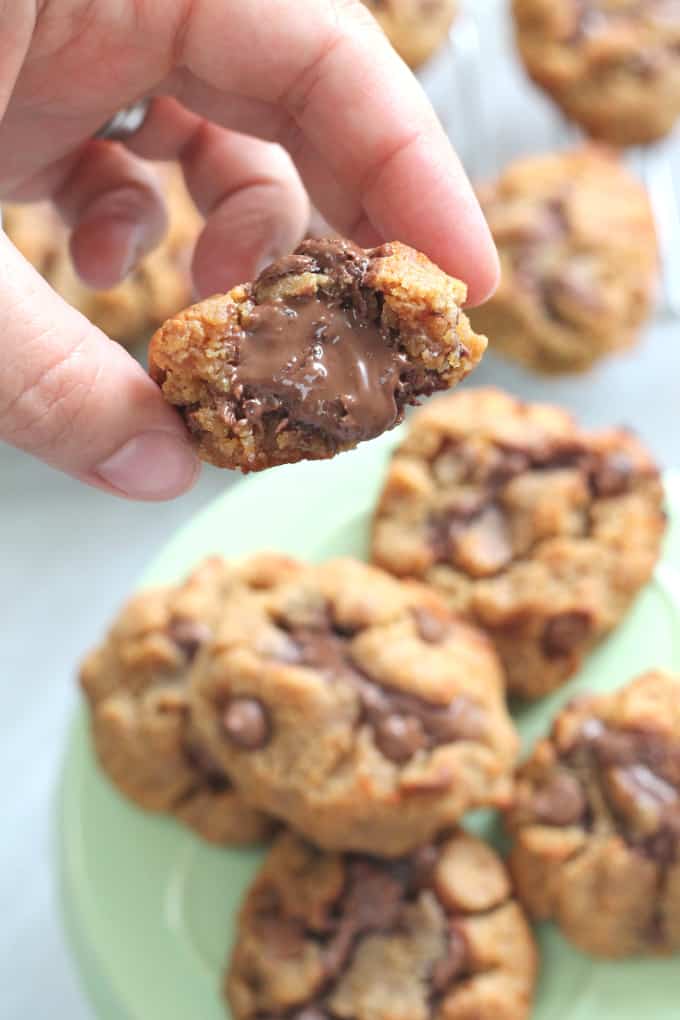 a hand holding a cookie to show the melting nutella middle