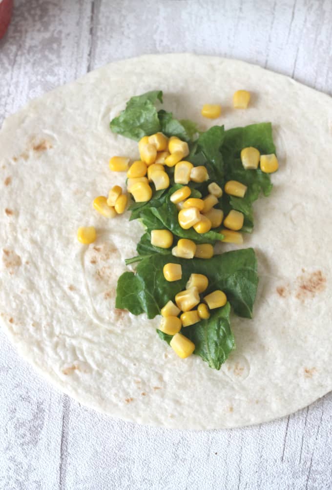 tortilla wrap with shredded lettuce and sweetcorn on top