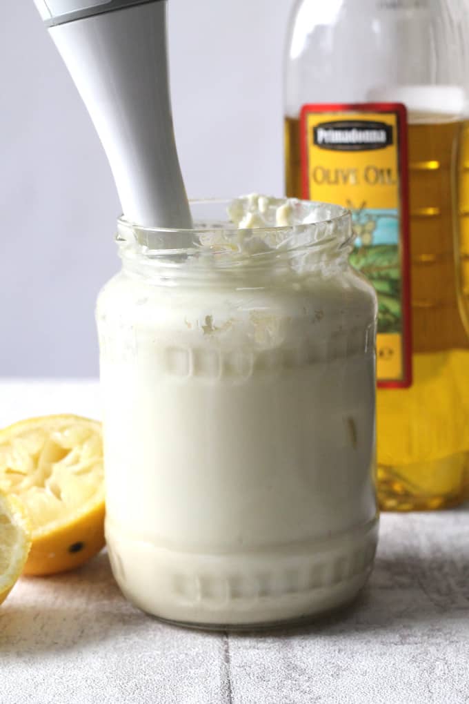 homemade mayo in a glass jar with a handheld blender in the jar