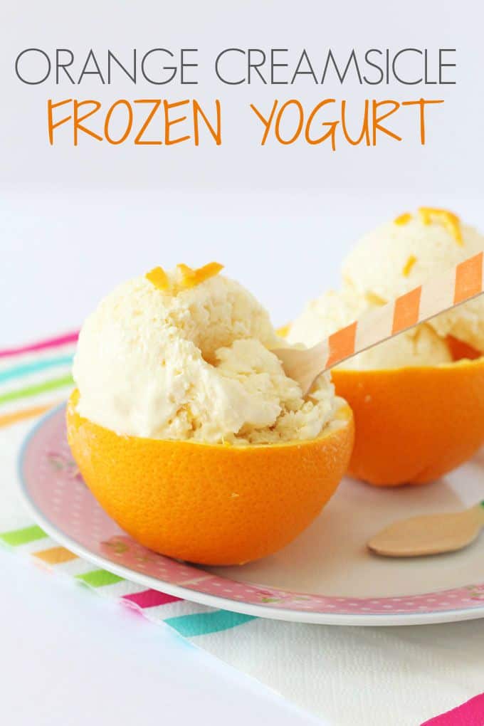 Orange Creamsicle Frozen Yogurt served in orange halves with a wooden spoon