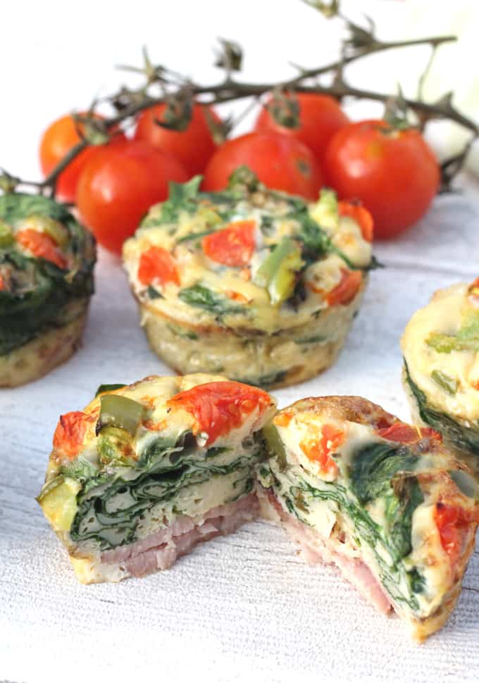 Spinach & Bacon Egg Muffins cut in half to show the layers within the egg muffins