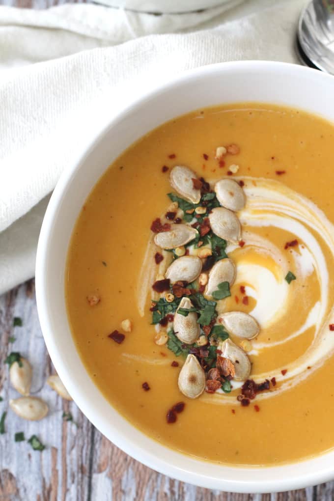 butternut squash soup topped with pumpkin seeds, creme fraiche and chilli flakes