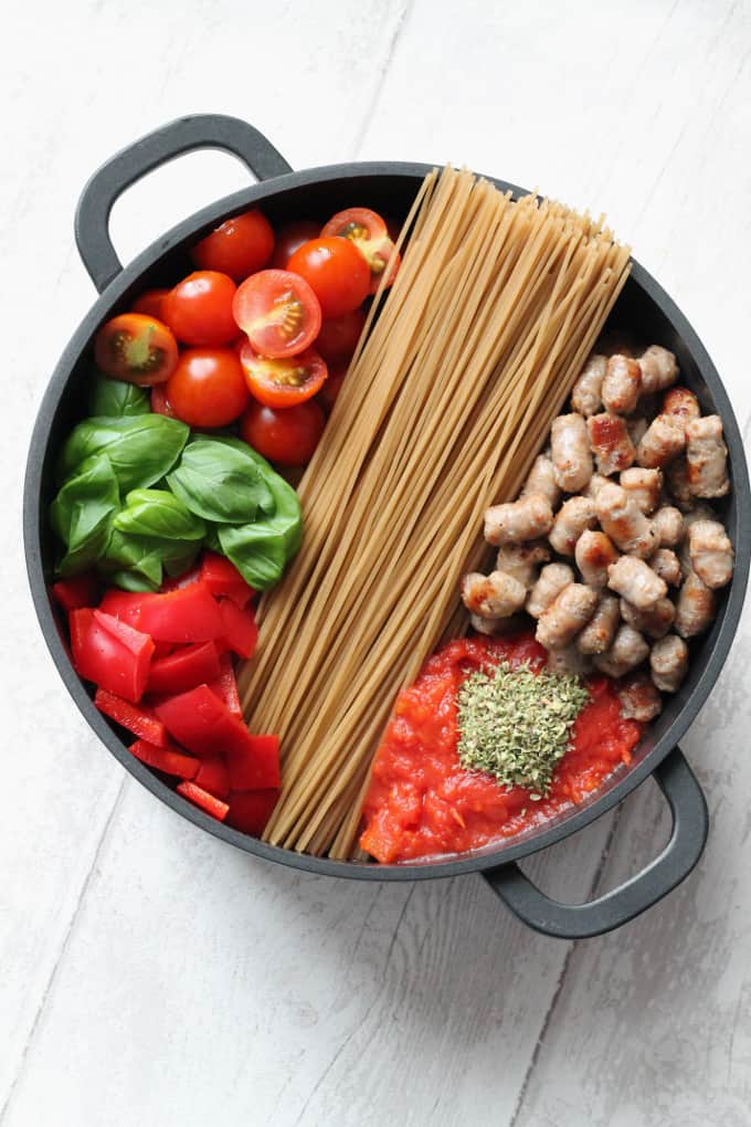 ingredients for one pot creamy pasta arranged in a large black saucepan