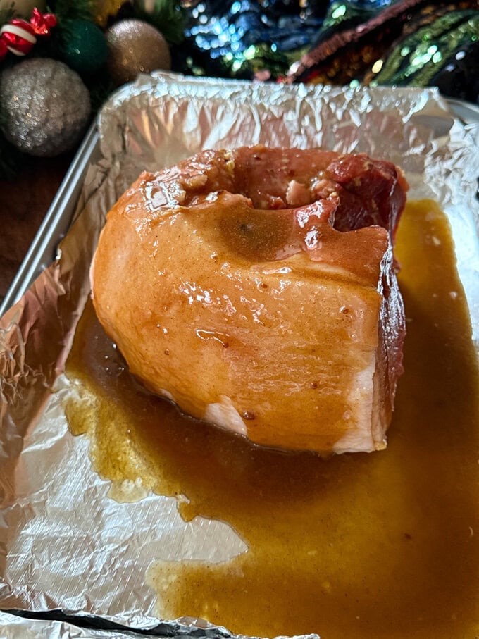 Christmas ham sat in a oven dish ready for the glaze.