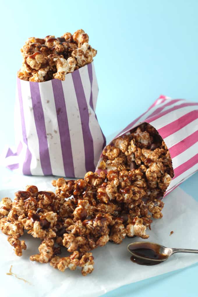 salted caramel chocolate popcorn with the salted caramel sauce drizzled over the top