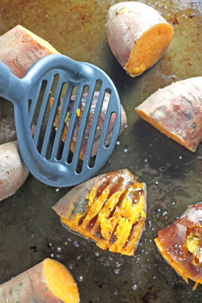 smashing the sweet potatoes with a masher