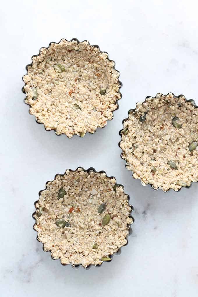 granola crust mixture pressed into mini tart tins