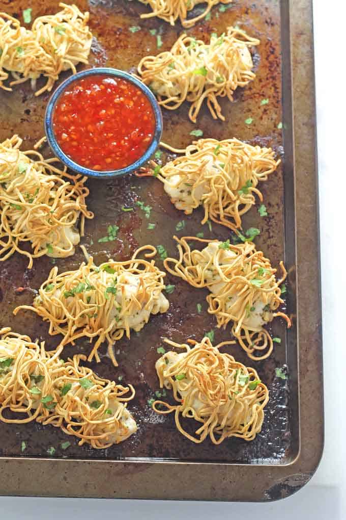 noodle wrapped chicken out of the oven on the baking tray