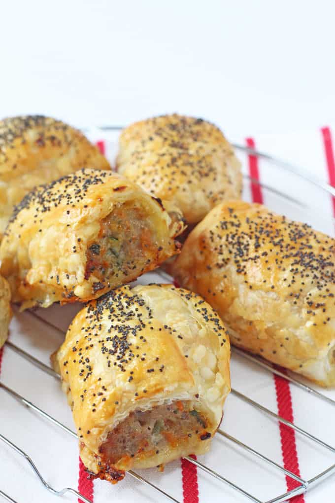 hidden veggie sausage rolls topped with poppy seeds