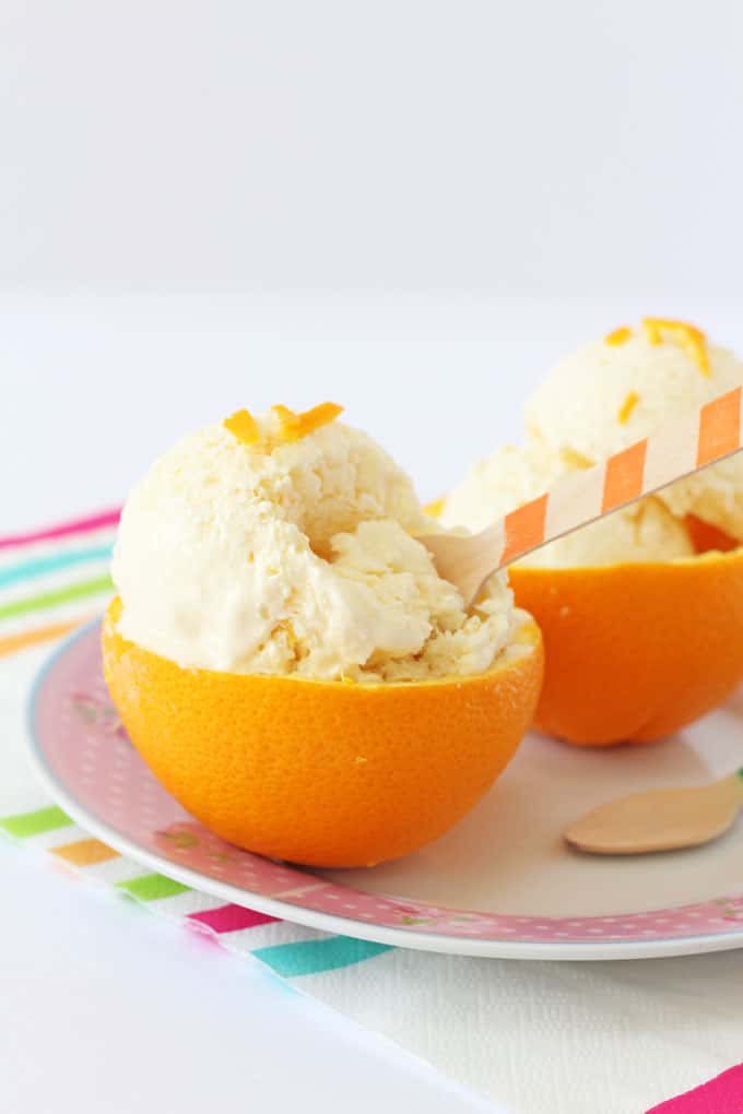 a close up of the dessert with an wooden orange stripy spoon sitting in it 