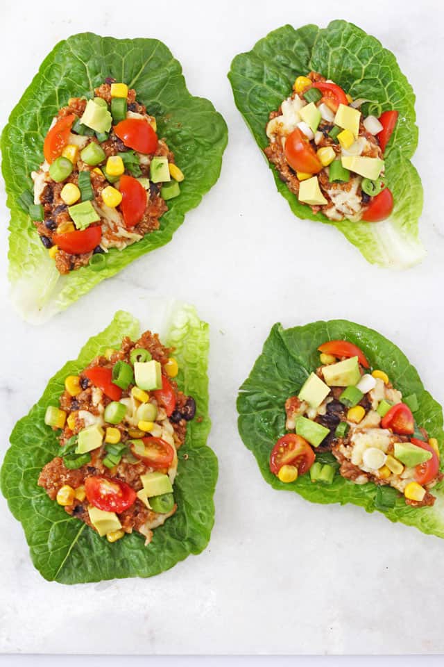 4 Slow Cooker Quinoa Lettuce Cups on a white marble background