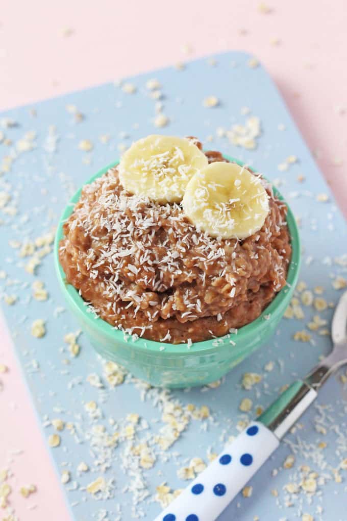 close up of the porridge topped with two slices of banana and desiccated coconut