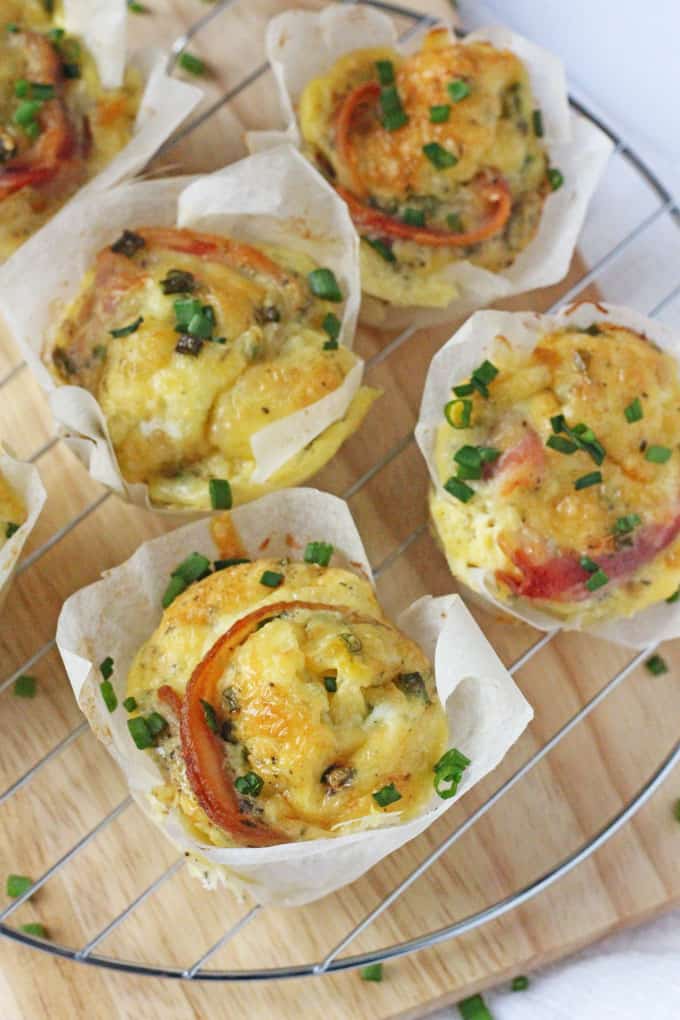 close up of the muffins on the wire cooling rack topped with spring onions