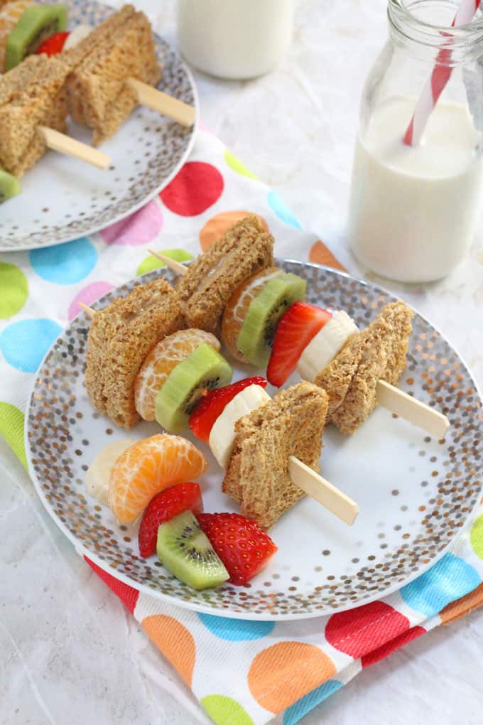 Breakfast Kebabs on a white and gold plate with a glass bottle of milk in the background.