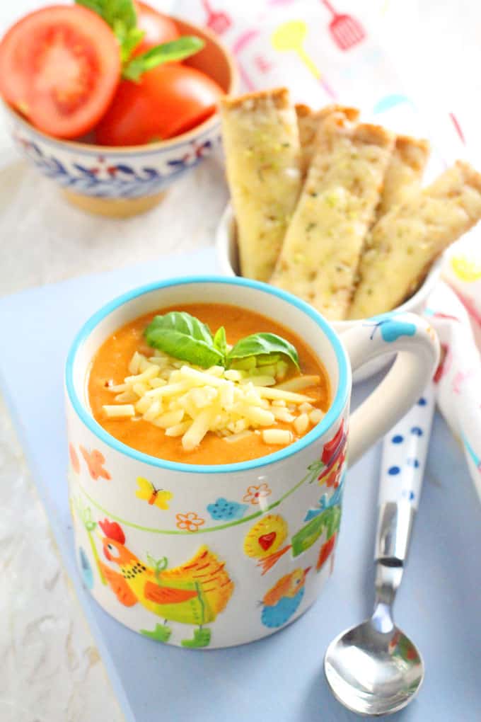 Roasted Tomato Soup served in a kug sprinkled with cheese and served with Cheddar Cheese Soldiers | My Fussy Eater blog