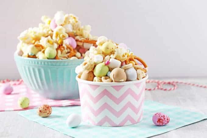 Easter Bunny Trail Mix in a pink and white ice cream tub with a larger bowl of trail mix in the background