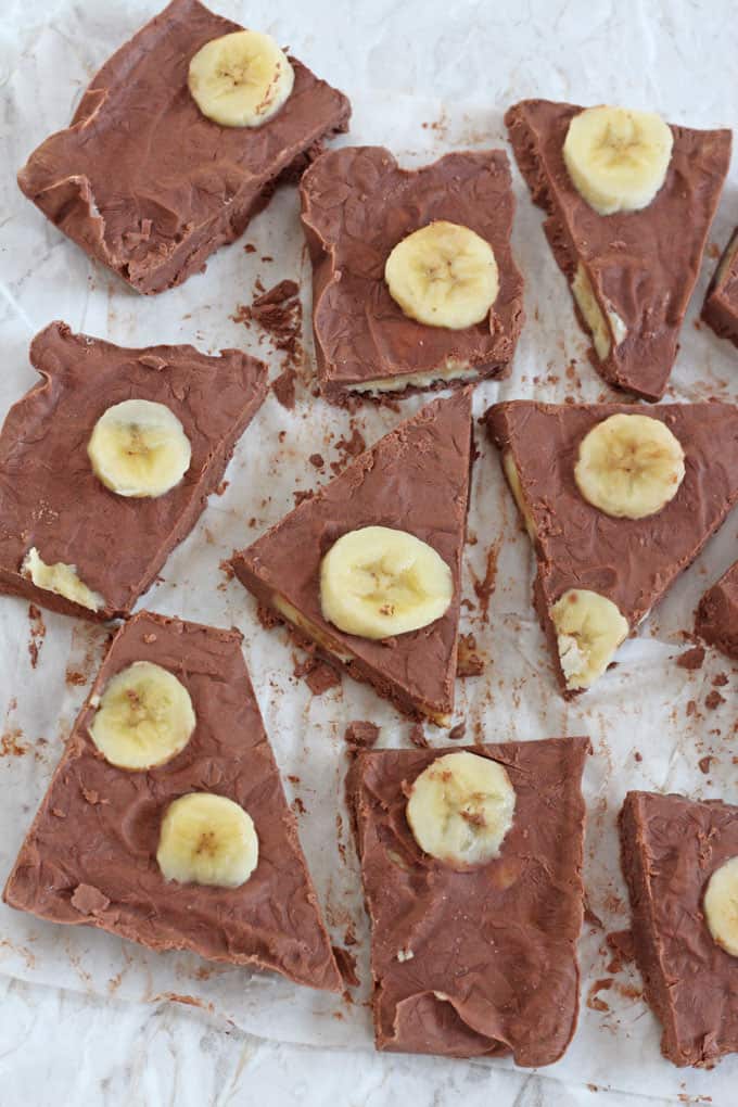 Chocolate Banana Frozen Yogurt Bark cut into squares on a sheet of parchment paper.