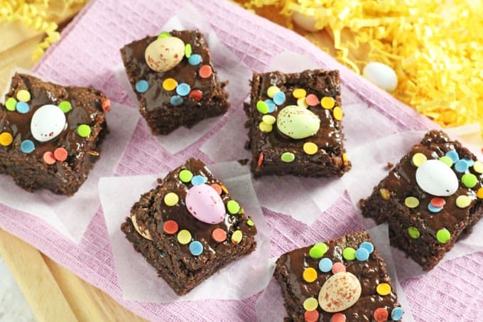 Mini Egg Easter Brownies decorated with mini eggs and confetti sprinkles