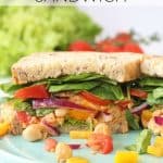 A delicious vegan sandwich packed with spicy sriracha chickpeas, lettuce, spinach, tomatoes and peppers. Perfect for a 2 minute healthy lunch for busy parents!