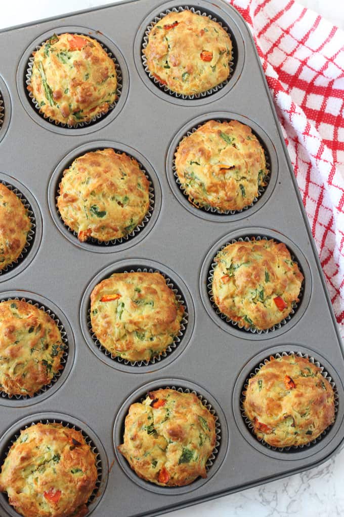 spinach & cheese savoury lunchbox muffins presented in a oven proof muffin tin.