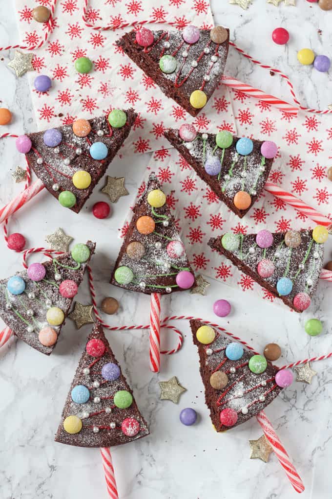 Christmas Tree Chocolate Cake Pops on candy danes, decorated with smarties and edible silver balls.