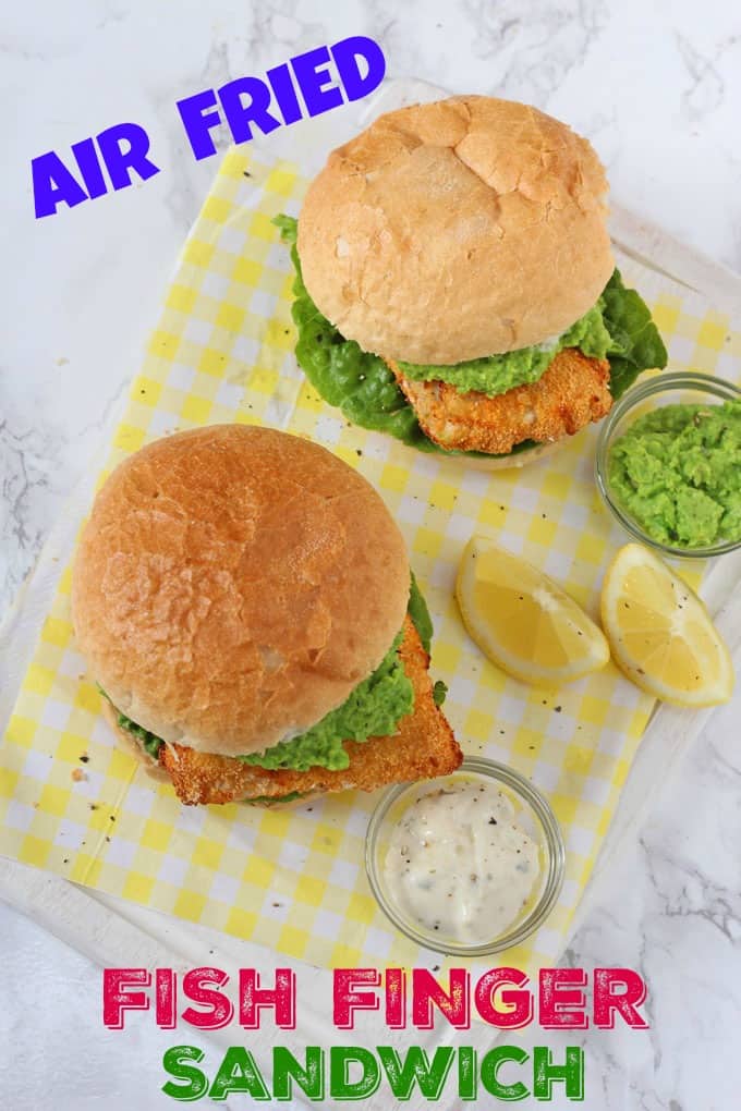 Air Fried Fish finger sandwiches served on a yellow and white napkin with lemon wedges and a ramekin of tartare sauce