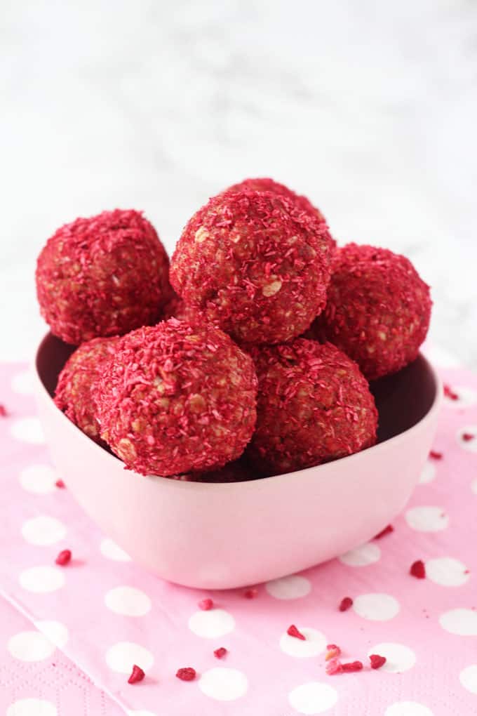raspberry & coconut energy bites in a pink melamine bowl