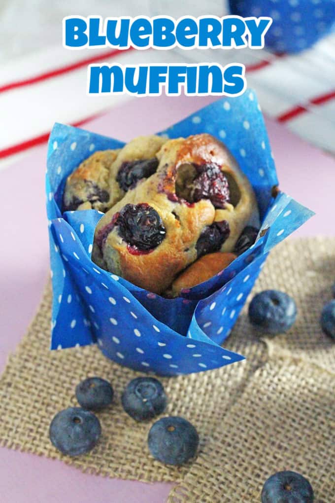 A Blueberry Muffin wrapped in a blue and white polka dot muffin casing on top of a hessian mat.