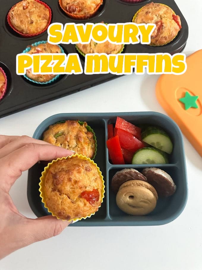 Savoury Pizza Muffins in a blue silicone lunchbox from Pick Plates, served with mini chocolate rice cakes and chopped veggies.