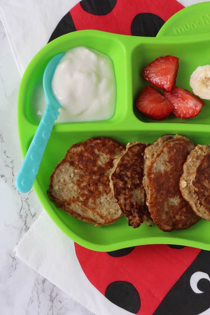 Close up of baby led weaning pancakes on a green plate