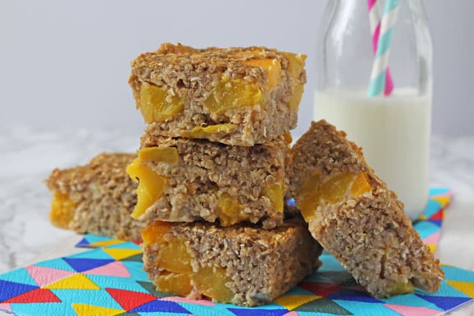 Peach Quinoa Breakfast Bars served with a small bottle of milk