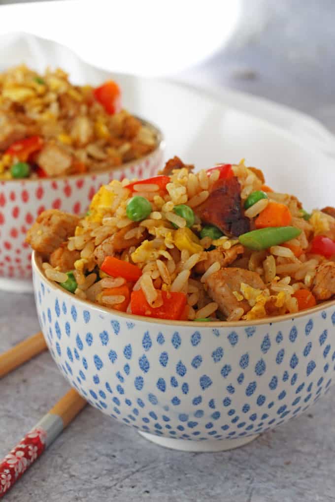 Quick & Easy Chinese Pork Fried Rice served in a blue and white chinese style bowl next to some chopsticks