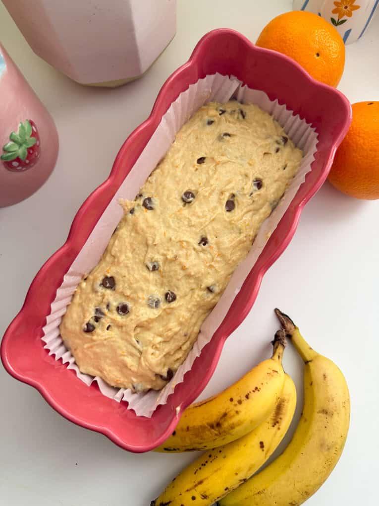 The Chocolate Orange Banana bread batter in the loaf tin lined with a parchment liner ready for the oven.