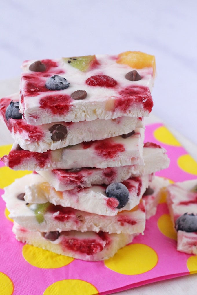 Fruity and Chocolate Chip Frozen Yogurt Bark stacked on a pink napkin
