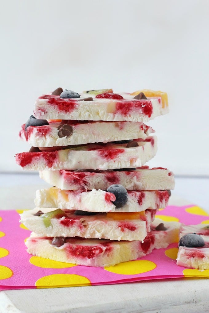 Fruity Raspberry Ripple Frozen Yogurt bark stacked on a pink and yellow napkin