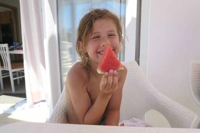 Child holding a piece of watermelon