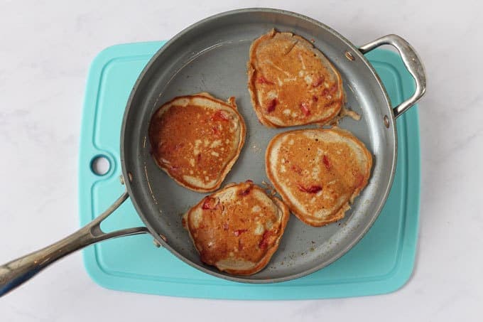 Frying pan with four strawberry yogurt pancakes