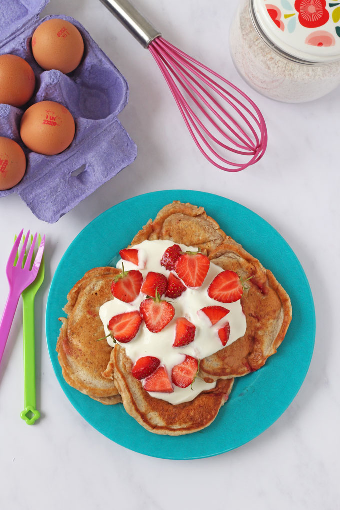 Strawberry Yogurt Pancakes topped with yogurt