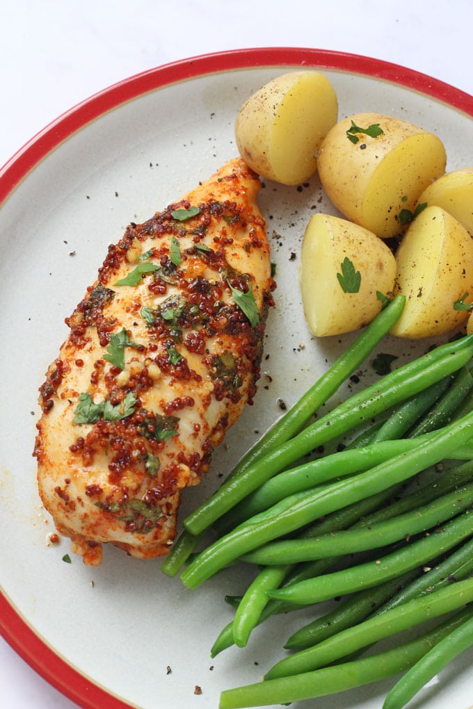 Honey Mustard Chicken Breast on a plate with potatoes and green beans