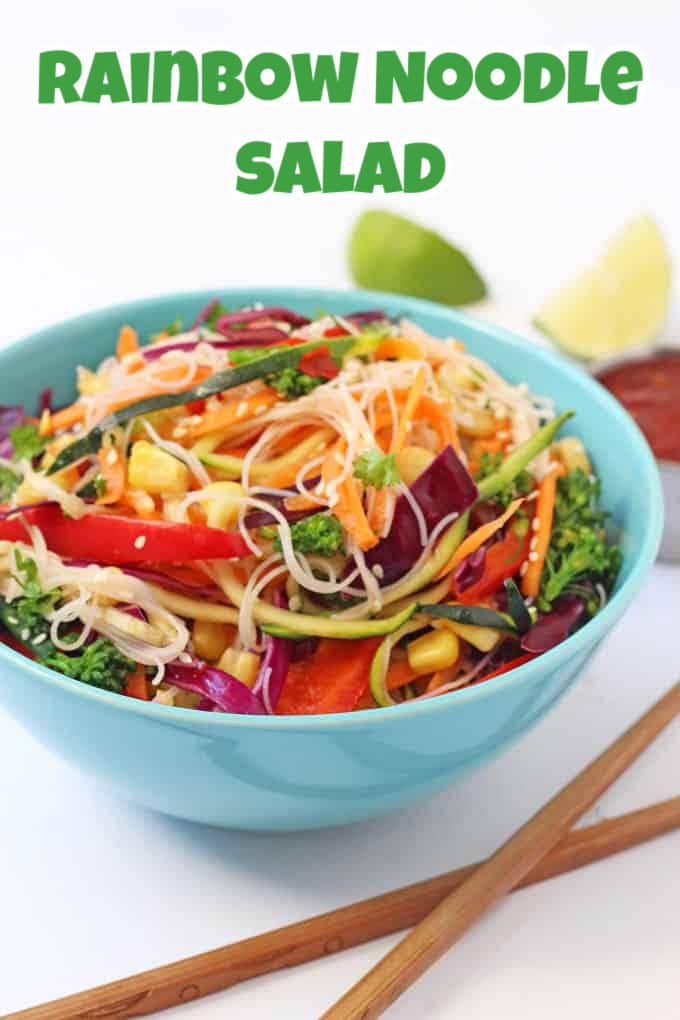 Rainbow Noddle Salad served in a brightly coloured blue bowl with a set of wooden chopsticks in the foreground.
