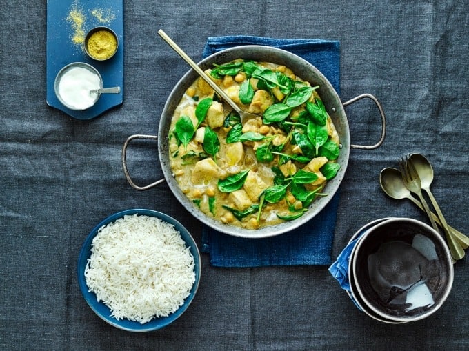 Coconut Chicken Curry in a large bowl with spinach and boiled rice