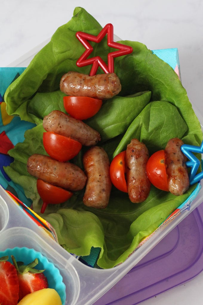 Close up of sausage and tomato skewers in a lunch box