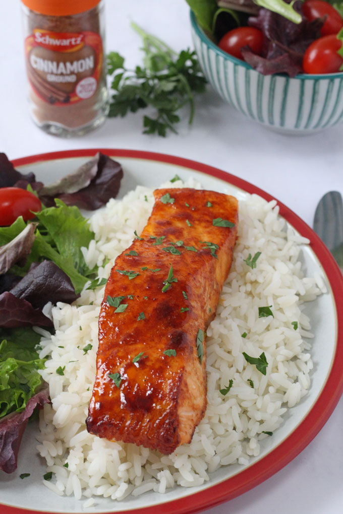 Cinnamon Spiced Salmon served with rice and a side salad.